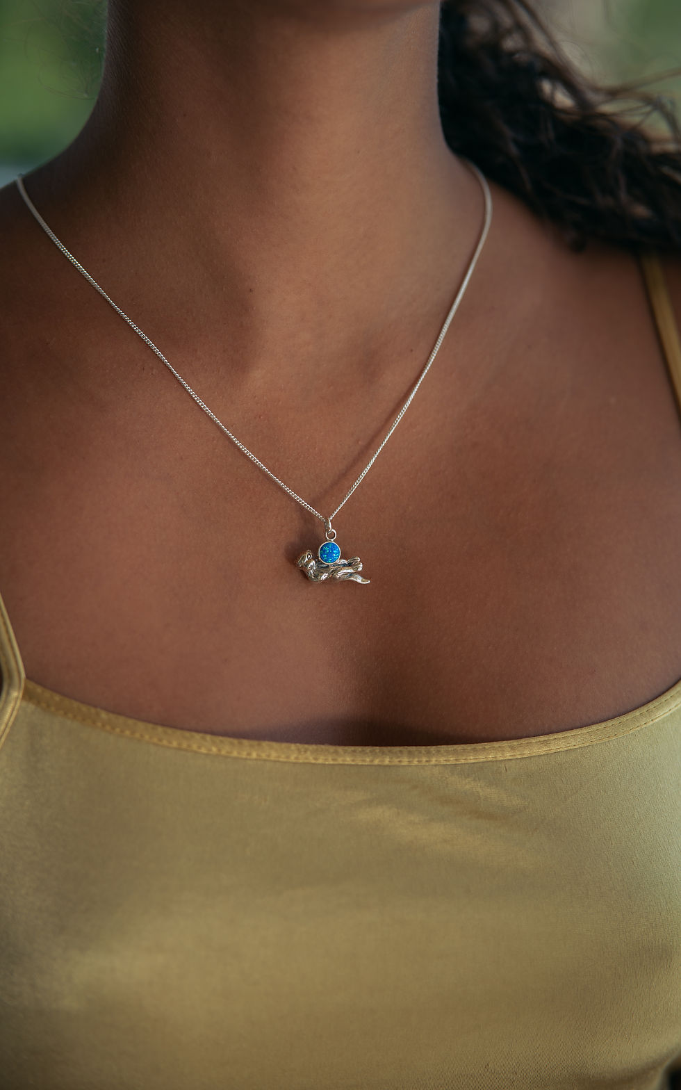 Thumbnail: Floating Sea Otter Holding Round Simulated Blue Opal Oxidized Silver Pendant - S
