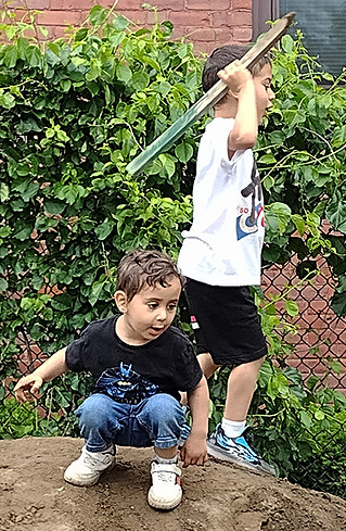 1688 - Mohammed and Elias playing on dirt pile.jpg