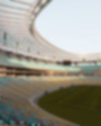 Interior of an empty Czech football stadium, sunset light on stands and pitch, architectural visualization.