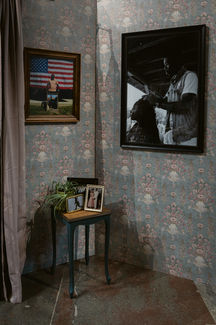 Framed documentary photography displayed inside the Still Here exhibition