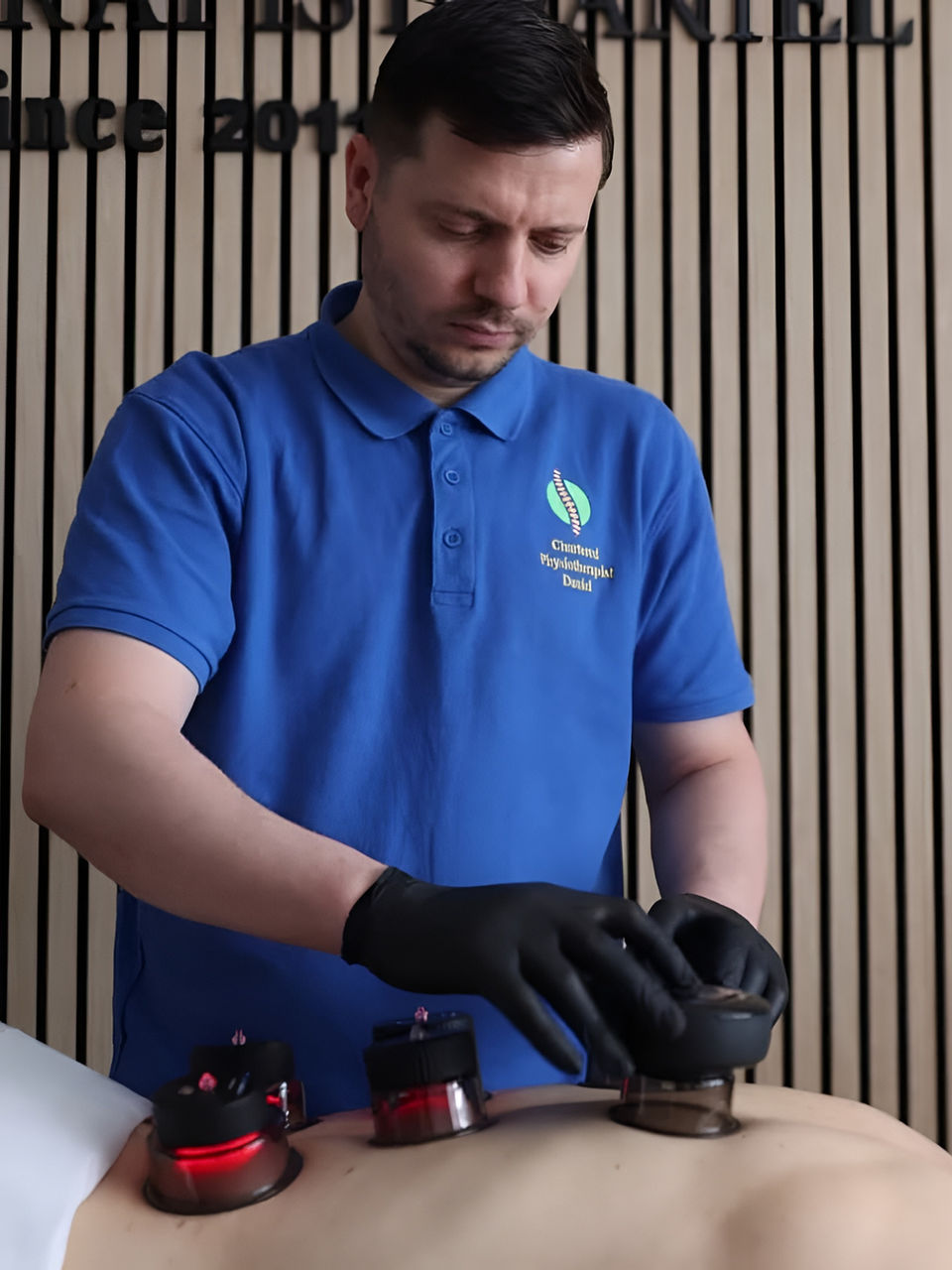 Physiotherapist performing rehabilitation with cupping