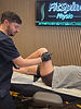 Physiotherapist performing knee rehabilitation