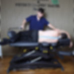 Physiotherapist performing spinal rehabilitation on mobilisation table