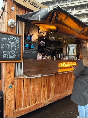 Lade next to a wooden hot chocolate stand