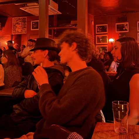 Students at a red-light pub/bar chatting