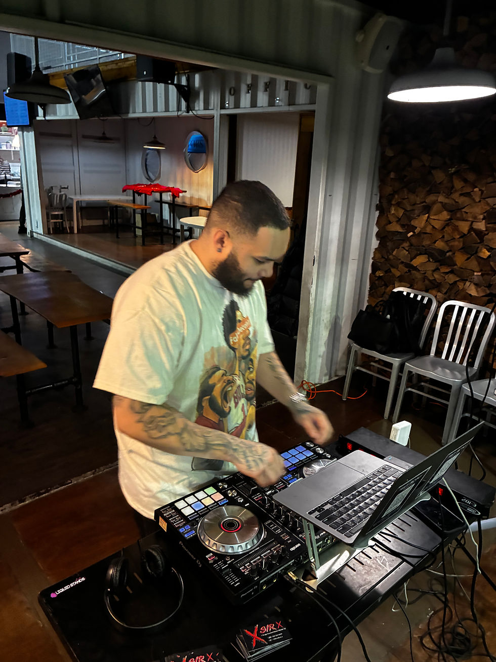 Photo of a DJ performing indoors at a venue