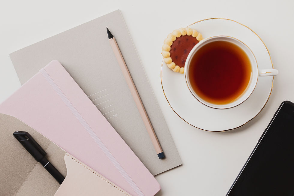 Coffee cup and open notebook on a table in natural light, representing planning and daily life
