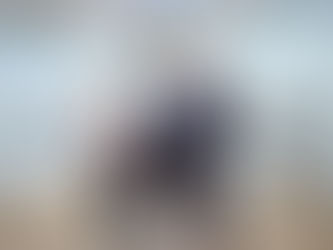 three people in a changing places bathroom with a hoist