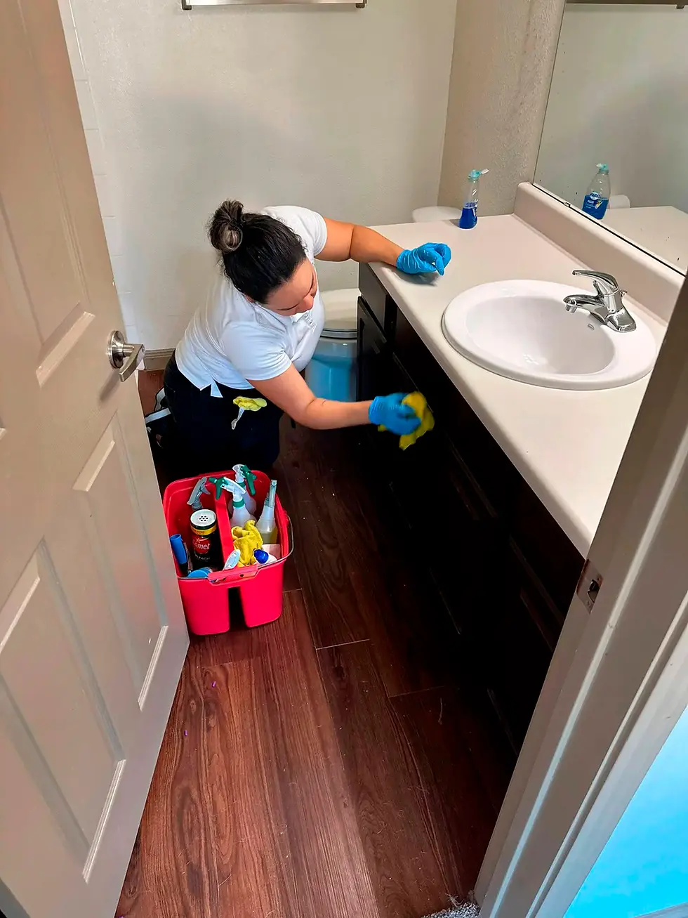 Torrent Cleaning team member cleaning a Suffolk County bathroom