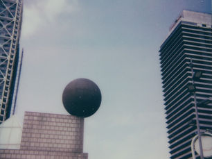 a polaroid of frank gehry's sphere in barcelona