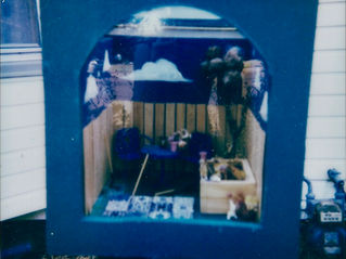 a small scene inside a box with a blue door