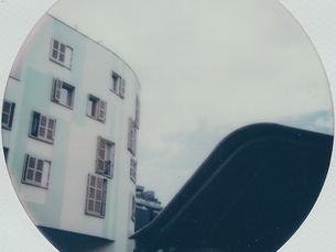 a polaroid of wavy buildings in barcelona