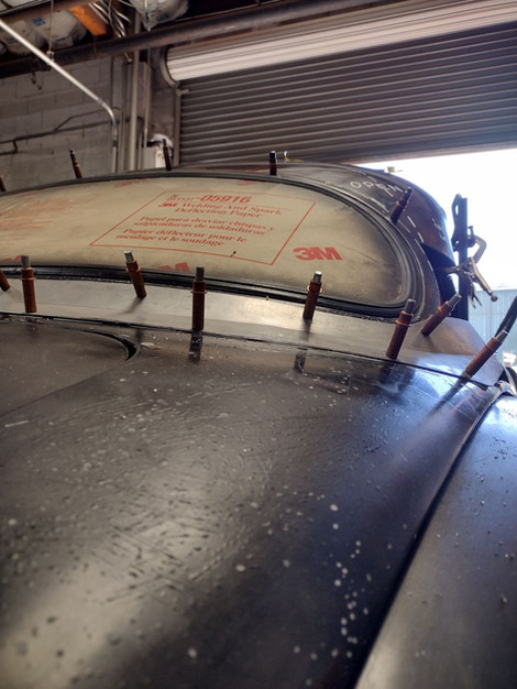 Spring clenched back window to trunk filler panel on the 1959 Jaguar XK150 by FFR Fabrication