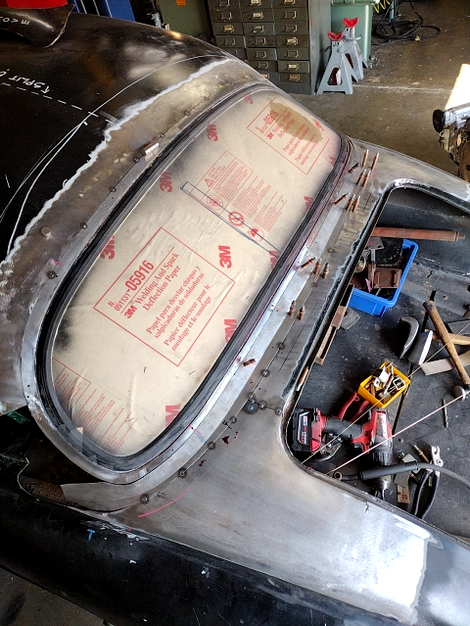 Spring clenched custom back window to trunk filler panel on the 1959 Jaguar XK150 by FFR Fabrication