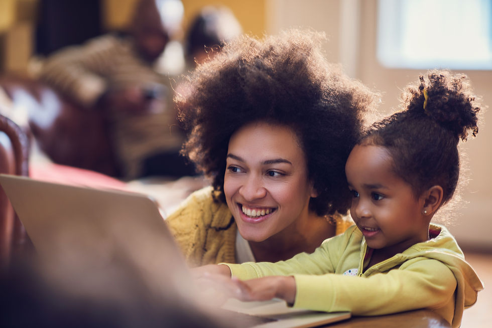 Happy-African-American-mother-and-her-little-daughter-using-laptop.-485954018_7360x4912.jp