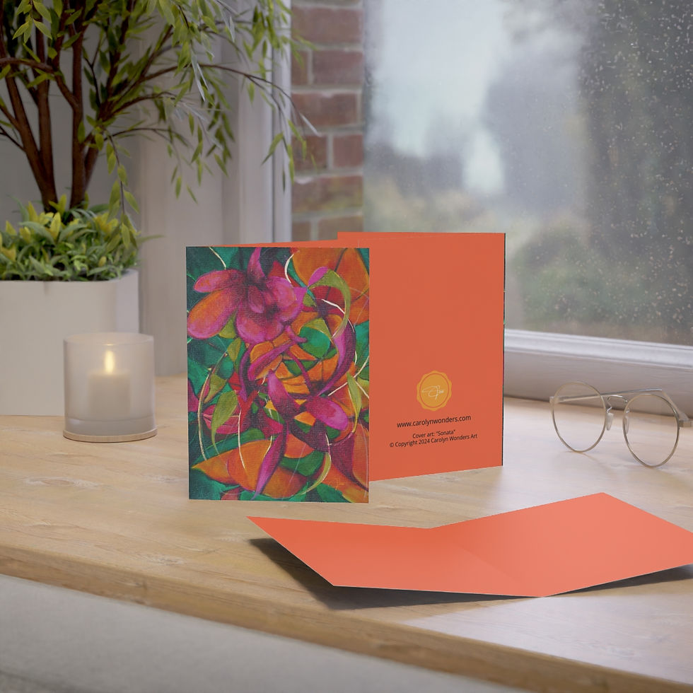 EcoArt Greeting Cards by Carolyn Wonders displayed on a table, with a candle, plant, window, and glasses in the background.