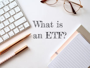 office supplies on a desk with the words "What is an ETF?"