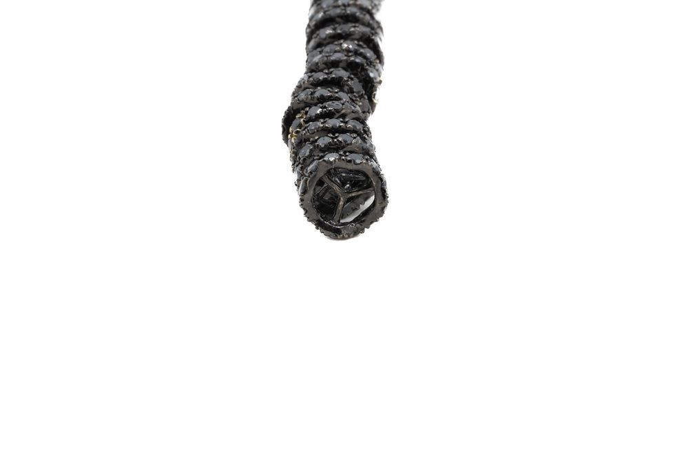 Miniature : Close up view of coiled Fan Black Sapphire jewelry with a white background.