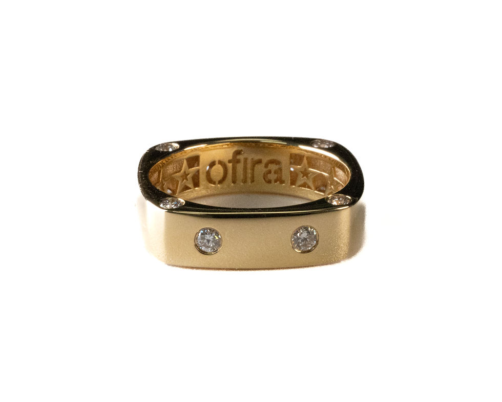 Gold ring with diamonds and visible "Ofira" text, Ofira Jewels.