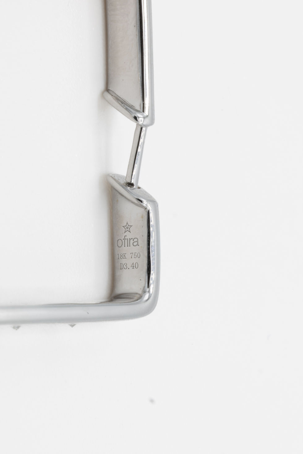 Miniatura: Silver metal jewelry with the Ofira Jewels logo and markings on white background