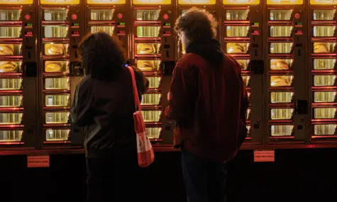 People-buying-hot-food-from-a-snack-vending-machine.webp