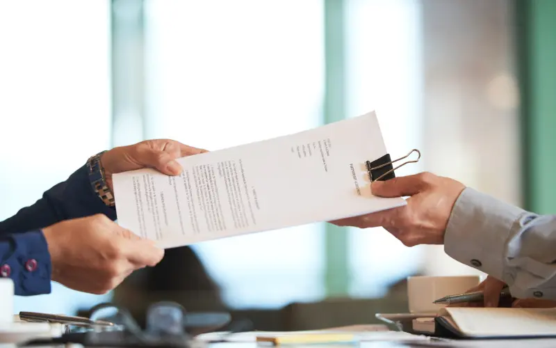 Closeup of hands exchanging contracts to start vending