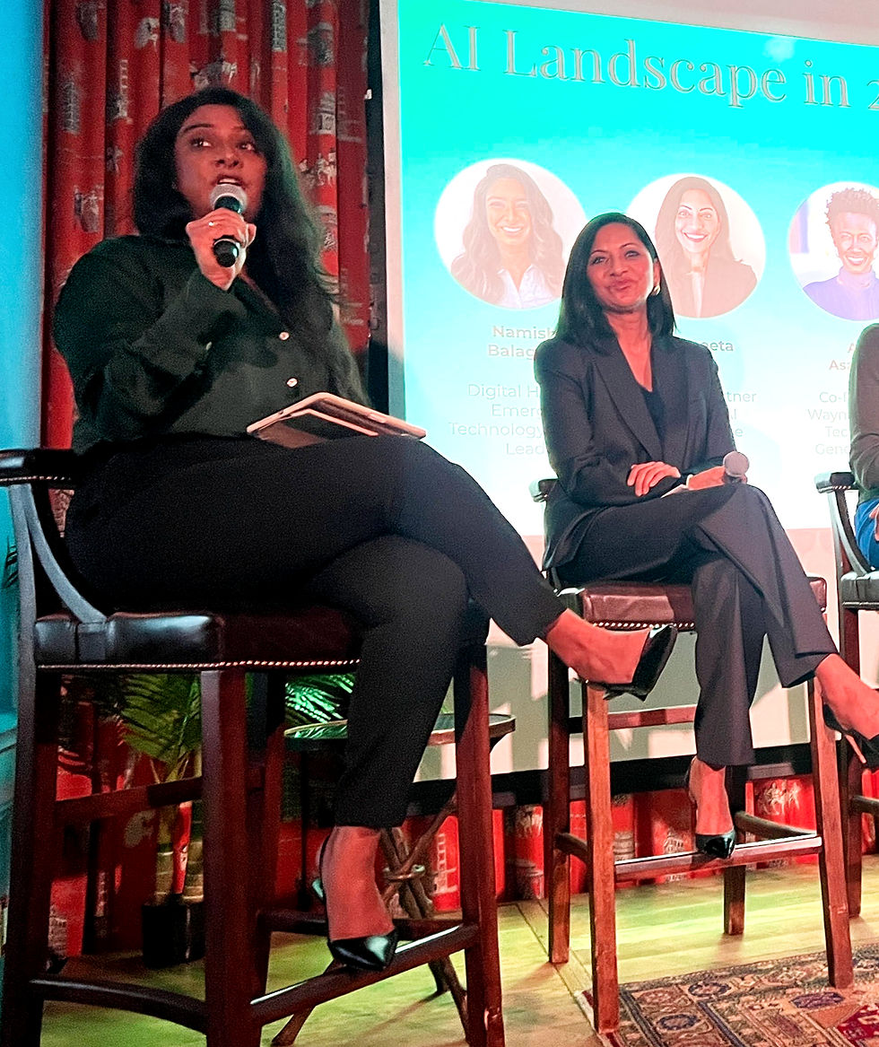 Two women seated on stage with microphones, discussing AI. Background shows a slide titled "AI Landscape in...". Red curtains and green plants visible.