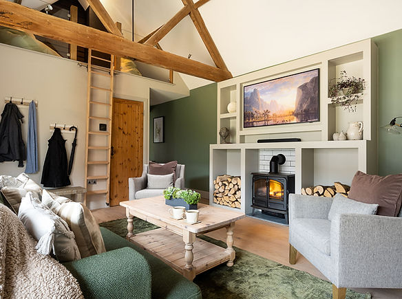 Lantern Lodge open plan living area showing exposed beams and mezzanine