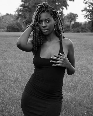 A black women posing for a photo
