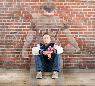 great oak high school senior football player in a letterman jacket with his image in uniform superimposed on a brick wall in old town temecula california