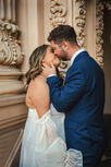 San Diego bride and groom sharing a kiss at the Organ Pavilion in Balboa Park.