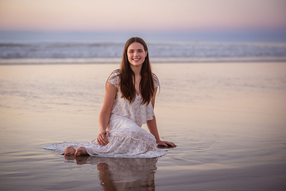 murrieta valley high school senior sitting in water on the beach in san diego