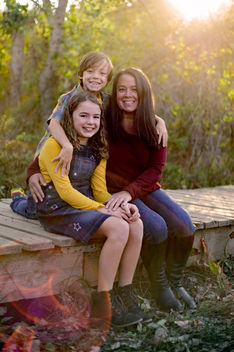 mom and kids sitting and enjoying fall in fallbrook california at golden hour