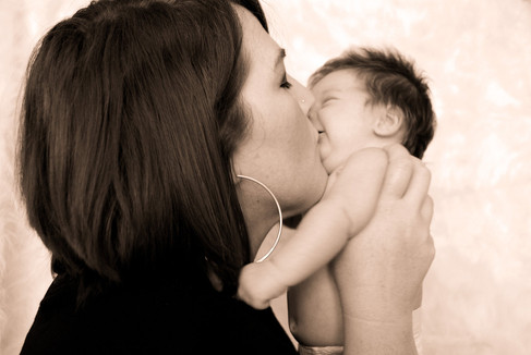 mom smooching her little baby