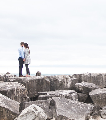Couple on rocky shore