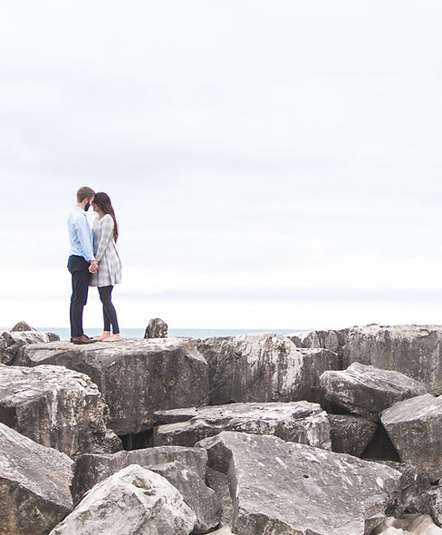 Couple on rocky shore