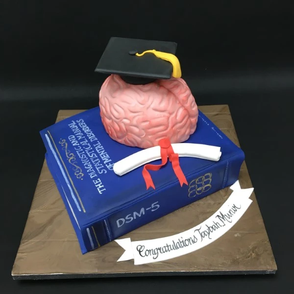 Bespoke brain-shaped graduation cake designed as an open book, crafted in Solihull, West Midlands.