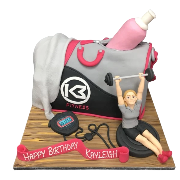 Bespoke celebration cake shaped like a gym bag with a lady figure, crafted in Solihull, West Midlands.
