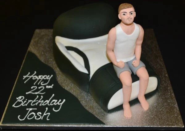 Bespoke boxing glove cake with a figure topper, crafted for celebration in Solihull, West Midlands.