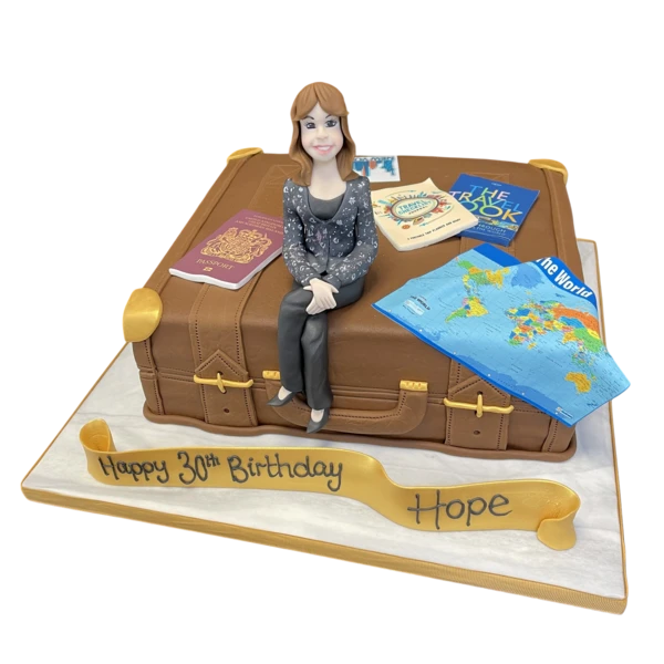Bespoke cake shaped like a vintage traveller’s suitcase with travel stickers, crafted in Solihull, West Midlands.