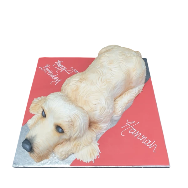 A beautifully decorated dog-shaped novelty cake, perfect for animal lovers and special occasions.