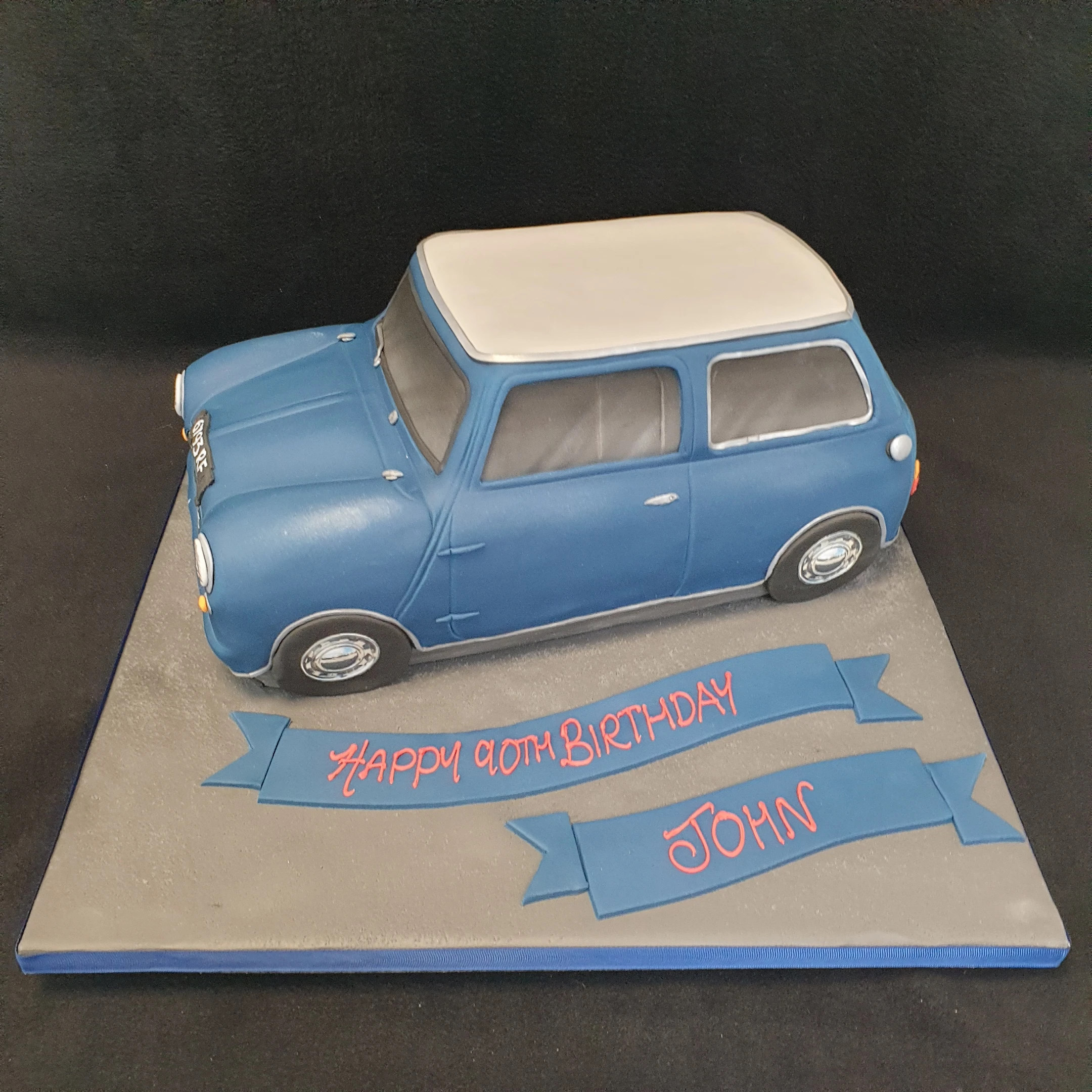 A beautifully crafted Austin Mini Mk1 car cake with intricate details and vibrant colours, perfect for car enthusiasts and special occasions.