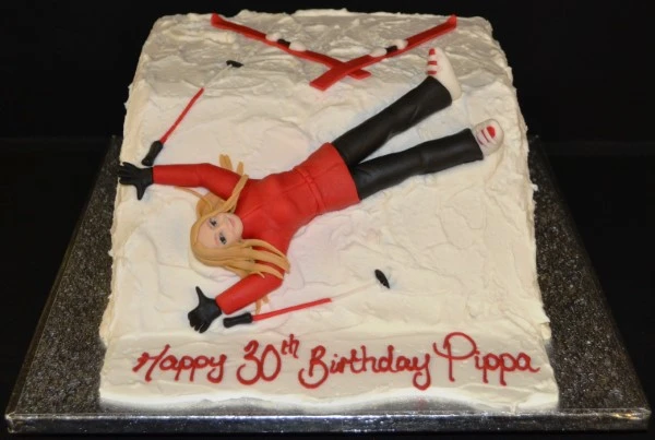 Bespoke ski slope cake with snowy peaks and ski tracks, crafted for celebration in Solihull, West Midlands.