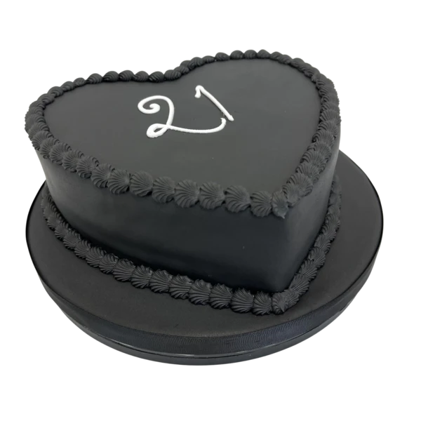 Bespoke black heart-shaped cake with intricate red piping details, perfect for celebration in Solihull, West Midlands.