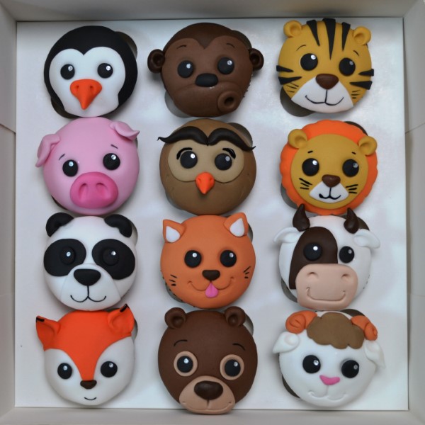 Bespoke celebration cake in Solihull, West Midlands featuring detailed animal figures and vibrant natural decorations.