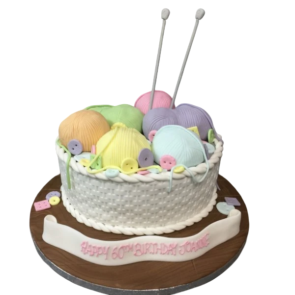 Bespoke cake shaped like colorful balls of wool in a woven basket, crafted for celebration in Solihull, West Midlands.