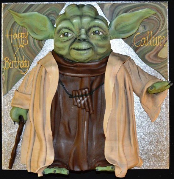A whimsical and detailed Yoda full-body cake, perfect for Star Wars fans or themed parties. Handcrafted with intricate design features.