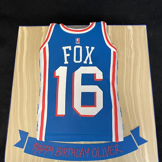 Bespoke Philadelphia 76ers basketball vest cake with detailed team logo, crafted in Solihull, West Midlands.