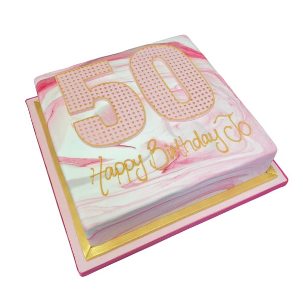 Marbled cake decorated with a golden shimmery Number 50 and stars for a milestone celebration.