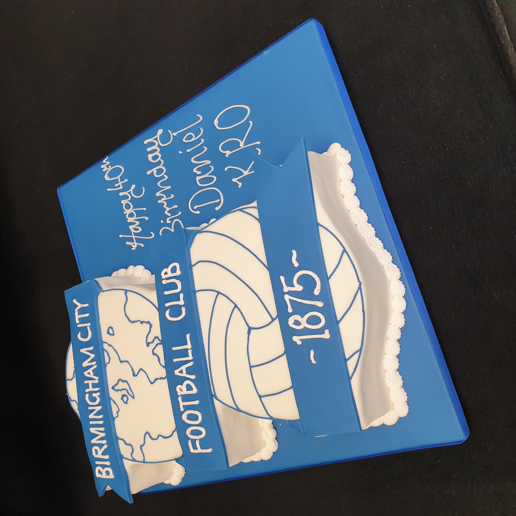 A football-themed cake featuring the BCFC Birmingham City Football Club badge, perfect for any passionate fan's celebration. Vibrant colors and intricate design.